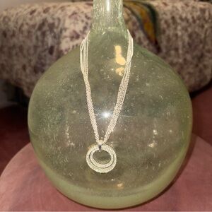 Silver toned 5 strand necklace with 2 rings of rhinestones